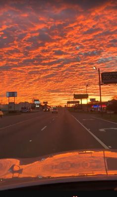 the sun is setting over an empty highway