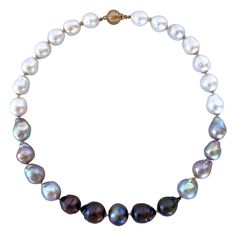 Gorgeous yet simple piece from Marina J. This beautiful necklace features high luster Baroque Black, Grey and White Pearls all carefully strung together to create the perfect ombre. Pearls graduate in size from light to dark, giving this piece a dynamic and dimensional look. Each Pearl displays a wild iridescent "oilspill" sheen and is accented by a 14K Yellow Gold cups. Necklace meets at a secure and decorative 14K Yellow Gold Bead Closure Clasp and measures 17.5 inches long, allowing it to sit Ombre Necklace, South Sea Pearl Necklace, Akoya Pearl Necklace, Pearl Strands Necklace, Necklace Clasp, Golden South Sea Pearls, J Black, White Pearl Necklace, Necklace Clasps