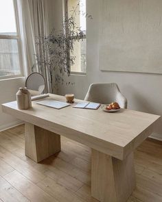 a wooden table sitting in front of a window