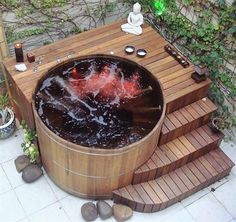 an outdoor hot tub in the middle of some steps