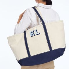 Crafted from durable canvas, this boat tote is perfect for anything from grabbing groceries to a day at the beach. Designed to last with a zipper closure, double stitched top handles, and a square base for added stability. A timeless gift, the contrasting accent color perfectly frames the personalization of your choice, whether it's a stylish monogram, a special date or a playful message.    Medium: 18"w x 5.5"d x 12"h  Large: 25"w x 9"d x 14"h  Handle drop: 9"  Canvas.  Spot clean only.  Import Rectangular Canvas Beach Bag With Canvas Lining, Navy Rectangular Canvas Bag, Monogram Maker, Boat Tote, Everyday Moments, Timeless Gifts, Custom Monogram, Williams Sonoma, School Days