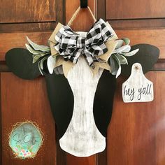 a door hanger with a cow's head on it