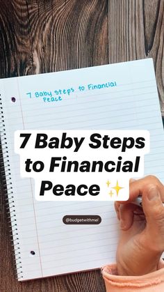 a person writing on a notebook with the title 7 baby steps to financial peace written above it