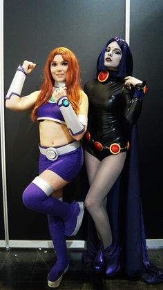 two women dressed in costumes posing for the camera