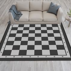 a black and white checkered rug in the middle of a living room with a couch