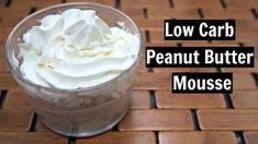 low carb peanut butter mousse with whipped cream in a glass on a wooden table