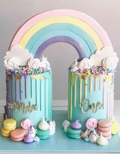 two cakes decorated with rainbow icing and sprinkles