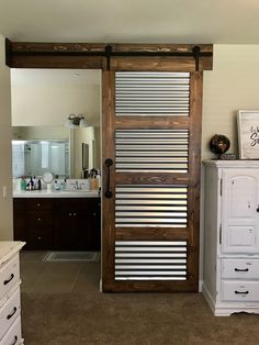 a bathroom with a sliding door that has slats on it