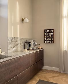 a bathroom with marble counter tops and wooden cabinets