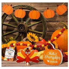 an assortment of pumpkins and decorations on a table