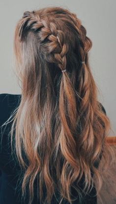 a woman with long hair in a half - up braid