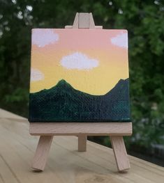 a small wooden easel with a painting on it