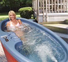 a woman in a hot tub on the patio