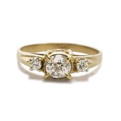 12K Yellow Gold VIntage Three-Diamond Ring. Ladies vintage 12k yellow gold and diamond ring. The gold tests 51% with an XRF metal analyzer. The ring weight is 2.3 grams gross weight. The center diamond is an old-cut, .50 carats, j color, i1 clarity. There is a natural near the edge and a small chip on a crown facet that can only be seen with 10-power magnification. The two side diamonds are round brilliants, i to j color, Vs to Si, .10 total carats. Ring size is 6 3/4 and can be sized, up or dow Antique Yellow Gold Diamond Ring With Vvs Clarity, Heirloom Three Stone Round Diamond Ring, Heirloom Three Stone Round Cut Cluster Ring, Heirloom Three Stone Diamond Ring, Heirloom Three Stone Cluster Ring Round Cut, Heirloom Three-stone Round Diamond Ring, Vintage Three-stone Round Cut Rings, Vintage Three Stone Round Cut Rings, Vintage 14k Gold Three-stone Rings