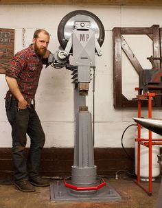 a man standing next to a machine in a room