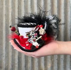 "Often copied, never duplicated. This is a Chiki Bird Original Design. Don't be fooled by knock-offs. THIS IS A MICRO MINI TOP HAT...It fits in the palm of your had! `The Queen of Hearts, she made some tarts, All on a summer day: The Knave of Hearts, he stole those tarts, And took them quite away!' The Accusation! That sweet little White Rabbit heralds the accusation to the jury! What say you? I say innocent. Who would want the Queen's tarts anyway? I bet they are all sour and yucky! This hat fe Mad Hatter Alice In Wonderland, Mad Hatter Hat, Mini Hat, Mini Top Hat, Tea Party Hats, Top Hats, Mad Tea Party, Mini Top, Bohemian Living