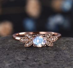 a close up view of a rose cut diamond ring on top of a stone surface