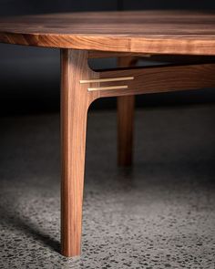 a wooden table sitting on top of a carpeted floor