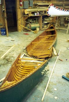 two canoes sitting on the ground in a workshop