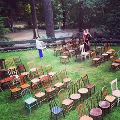 two people standing in the middle of a circle of chairs