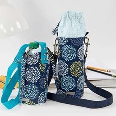 two purses sitting next to each other on top of a white table with pencils