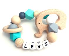 a wooden beaded elephant with letters spelling it's name levi on the beads