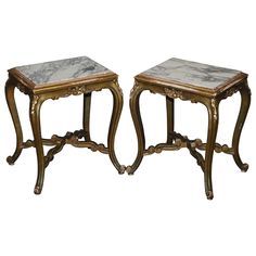 two tables with marble top sitting next to each other