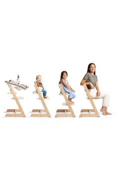 a group of children sitting on top of wooden ladders with their feet in the air