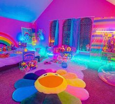 a room with lots of toys and decorations on the floor in front of a rainbow colored wall