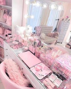 a pink vanity with lots of items on it