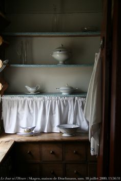 a shelf with dishes on it in a room