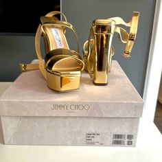 Never Worn, Brand New Gold Jimmy Choo Sandals! Mint Condition, Size 6 1/2! Designer Gold Sandals With Heel Loop, Luxury Gold Platform Sandals, Luxury Gold Platform Heels, Designer Gold Sandals With Round Toe, Designer Gold Sandals With Wrapped Heel, Designer Gold Platform Sandals, Luxury Party Sandals With Wedge Heel, Designer Platform Sandals For Party, Designer Gold Closed Toe Sandals