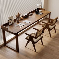 a wooden desk with two chairs next to it