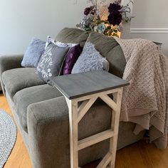 a living room with a gray couch and pillows