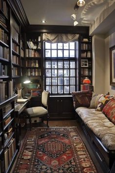 a living room filled with lots of furniture and bookshelves next to a window