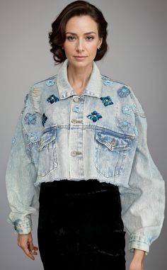 Discover our unique Embroidered cropped Jeans Jacket, a true standout piece for your wardrobe. This jacket is meticulously crafted and adorned with one-of-a-kind embellishments, all made from upcycled materials, ensuring that the piece is 100% sustainable. The cropped silhouette adds a modern twist to this classic denim staple, while the intricate embroidery adds a touch of elegance. Perfect for  day to night adding a statement to any outfit, this jacket is a must-have for eco-conscious consumer Spring Denim Cropped Jacket, Spring Cotton Cropped Denim Jacket, Spring Cropped Cotton Denim Jacket, Spring Denim Embellished Outerwear, Spring Embellished Denim Outerwear, Fitted Cropped Denim Jacket For Spring, Embellished Blue Denim Jacket For Spring, Spring Embellished Blue Denim Jacket, Embellished Long Sleeve Cotton Denim Jacket