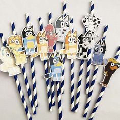 several paper straws with cartoon characters on them