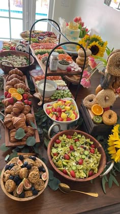 a table filled with lots of different types of foods and desserts on top of it