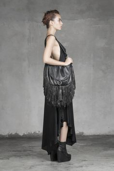 "BOHEMIAN FRINGE BAG - HAUS OF SPARROW Our black lambskin bag, decked out with fringe details and side tassles. All the hardware is hand cast in house and inside you'll find a silk lining. Great for travel or festivals. DETAILS -100% lambskin -inside zip pocket -snap closure -silk lining -side tassel -hand cast hardware -Length 40cm, Width 9cm, Height 32cm (not including fringes) WHY SPARROW?  Monica Wallway is a leader in the \"Slow Fashion\" movement, with a small workshop in Bali where she, Jan, and several other craftsmen make all Sparrow clothes by hand. Sparrow believes in quality over quantity, so we've crafted our garments to a premium level with an eye for details that transcend mass market trends. ----- Thanks for visiting Sparrow. Feel free to email us with any questions, sugges Luxury Fringe Tote Shoulder Bag, Luxury Fringe Shoulder Bag For Travel, Luxury Travel Bag With Fringe, Luxury Travel Shoulder Bag With Fringe, Evening Crossbody Bag With Tassels, Luxury Fringe Shoulder Bag, Evening Fringe Tote Bag, Luxury Travel Shoulder Bag With Tassels, Evening Shoulder Bag With Fringe