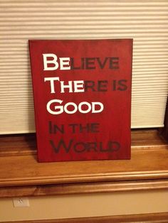 a red sign that says, believe there is good in the world