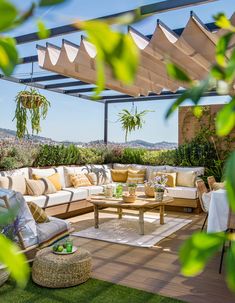 an outdoor living area with couches and tables