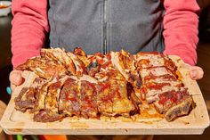 a person holding a tray full of sliced meat