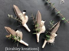 four boutonniers with white flowers and greenery