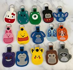 a bunch of different colored luggage tags on a white marble surface with an animal design