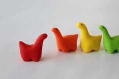 three small plastic ducks sitting next to each other