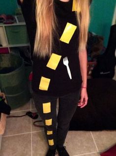 a woman with long blonde hair wearing black and yellow striped leggings