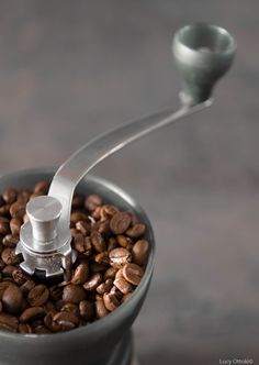 a coffee grinder filled with lots of coffee beans