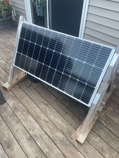 a solar panel sitting on top of a wooden deck