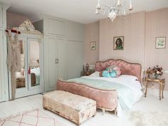 a bedroom with a bed, dresser and dressing table in it's center area