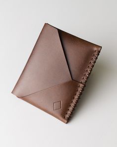 This is Catori - minimalistic but capacious wallet handcrafted from vegetable tanned Italian leather.  Designed for people who loves to stand out. Just look at that accent seam! For your convenience it also has 2 easy access slots for mostly used cards. Leather: Brown Buttero leather Thread: Brown Julius Koch Ritza 25 Buttero leather is known for its exceptional quality, it is a type of vegetable-tanned leather that is made using a natural and traditional tanning process, resulting in a rich, su Minimalist Brown Wallets As Gift, Minimalist Brown Trifold Wallet For Everyday, Minimalist Leather Trifold Wallet For Everyday, Minimalist Trifold Wallet For Daily Use, Minimalist Handmade Bifold Card Holder, Modern Handmade Leather Wallets, Minimalist Handmade Wallets For Everyday Use, Minimalist Handmade Wallet For Everyday Use, Minimalist Brown Trifold Wallet For Daily Use